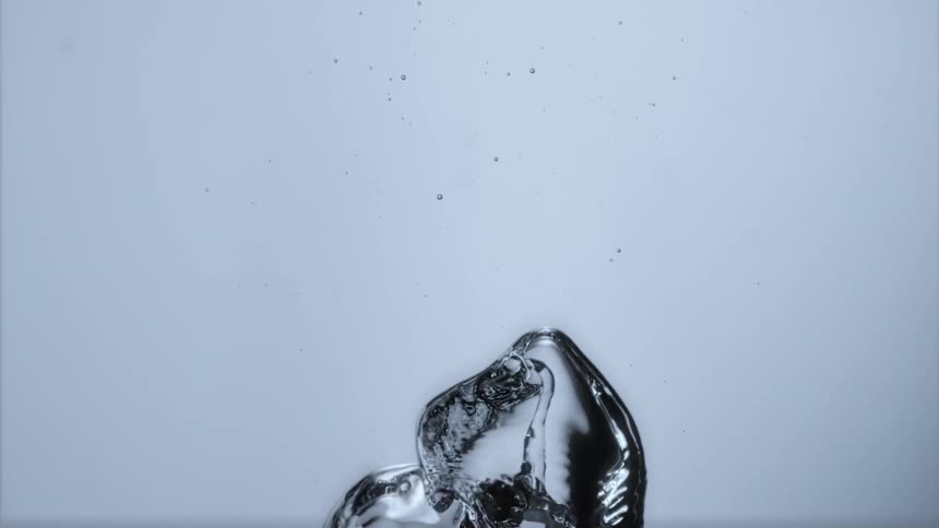 Bubbles surge upwards and rise in clear liquid