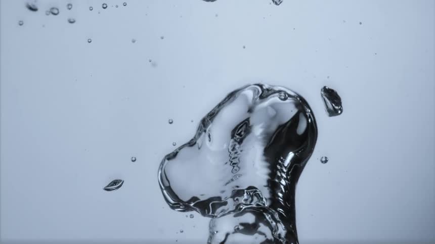 Bubbles surge upwards rising in clear liquid