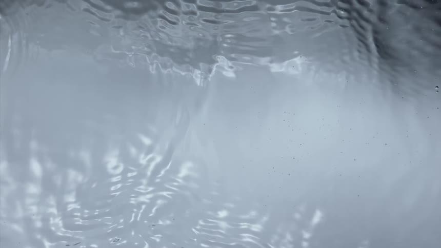 Clear water ripples and moves reflecting the light