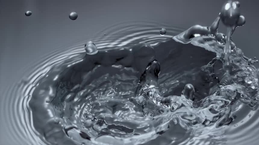 Droplets fall into water splashing and causing ripples