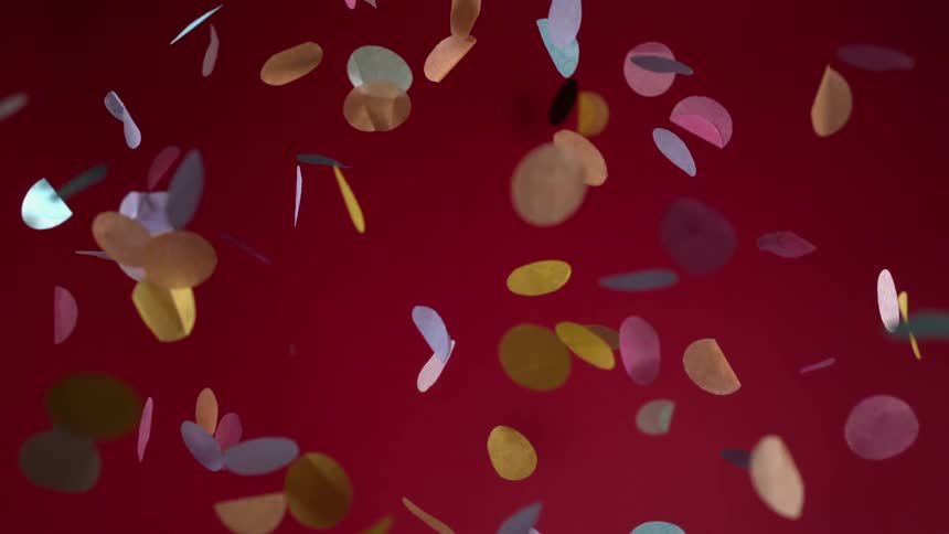 Paper circles are floating downward as they flip over