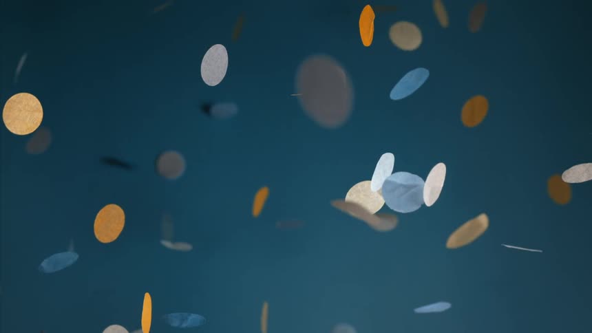 Colored dots are falling from above as their shadows move across a blue wall