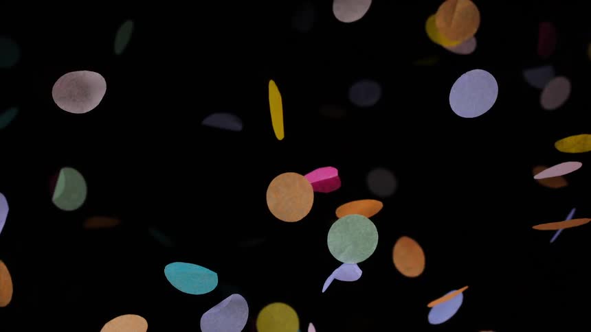 Colorful paper confetti falling in slow motion