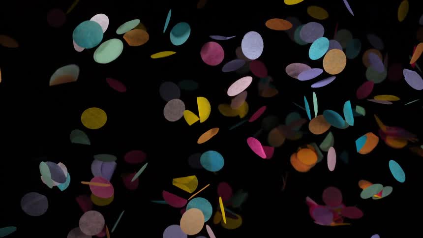 Colorful circular confetti falls slowly against a dark background
