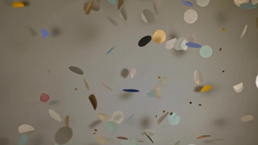 Paper confetti tosses and turns as it falls