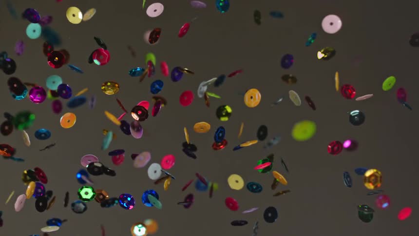 Colorful circular confetti float in the air