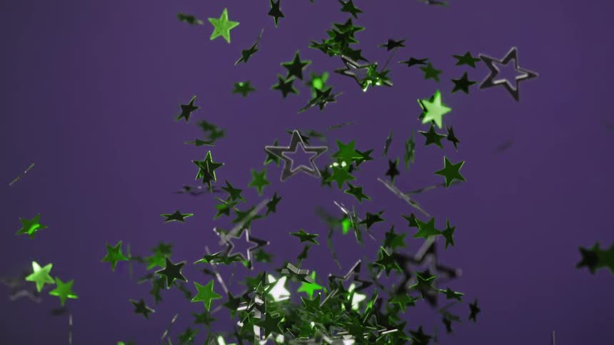 Confetti with green stars are being thrown into air on purple background