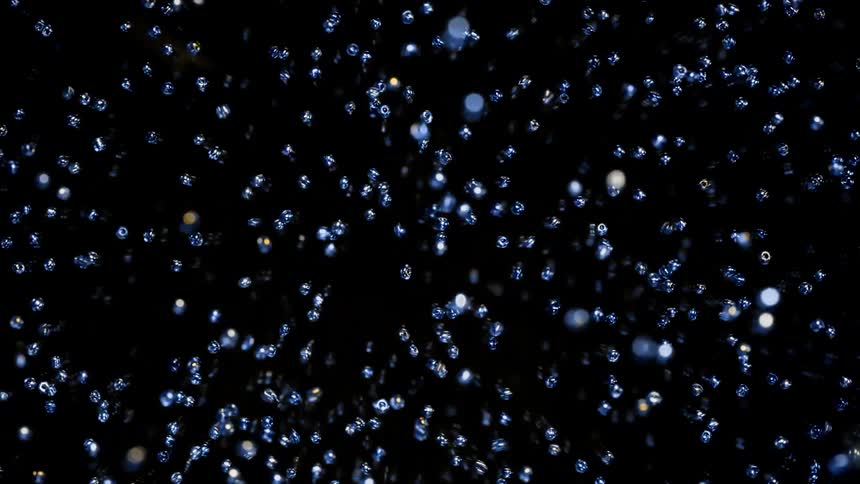 Cut diamonds and micro pearl fall down and move about on the black background