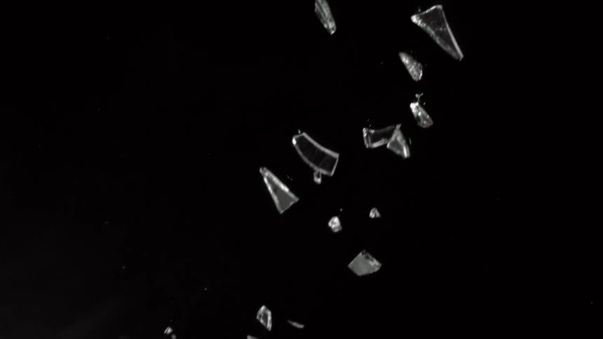 Glass shards of various size fall through darkness