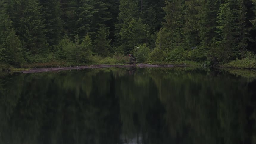 People are riding motorcycles near a lake