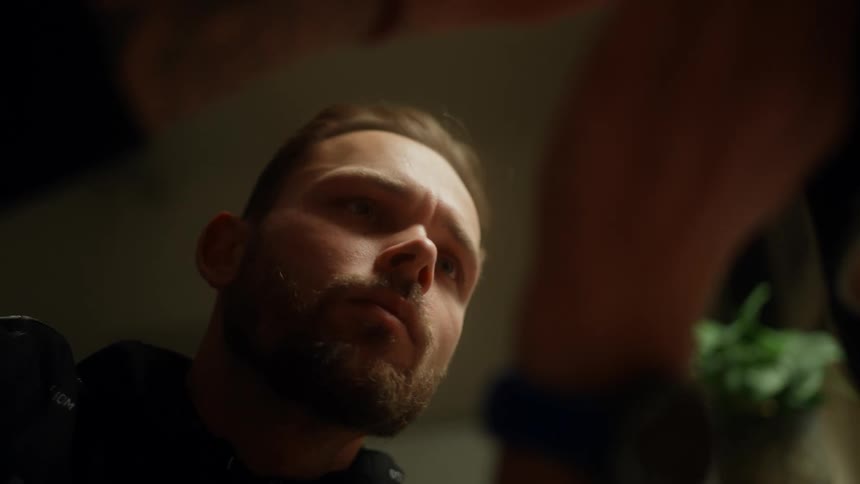 A man is focused on something he is working on with his hands