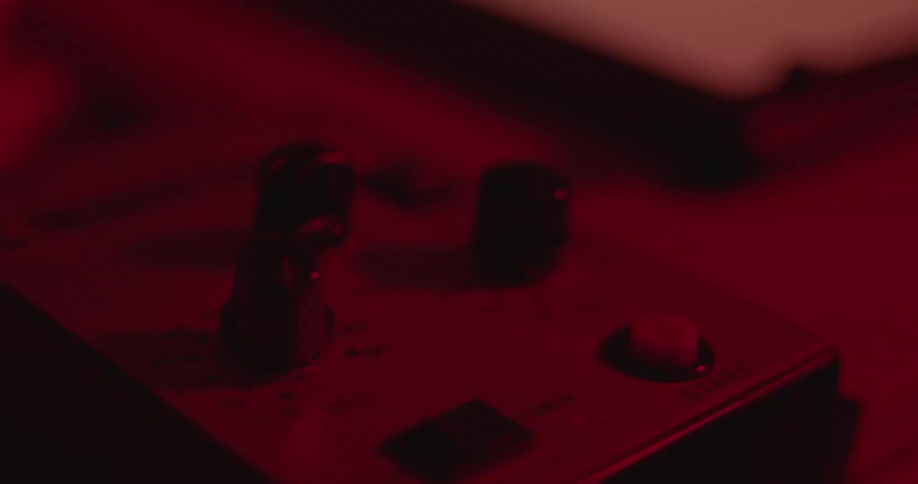 An employee touches a button on a switchboard