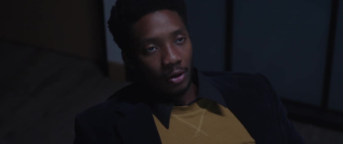 A male office worker looking disappointed after a phone call