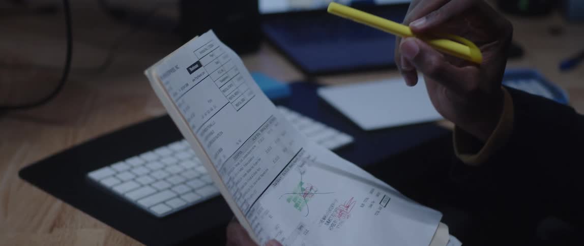 A male worker using a marker to point to something at a paper