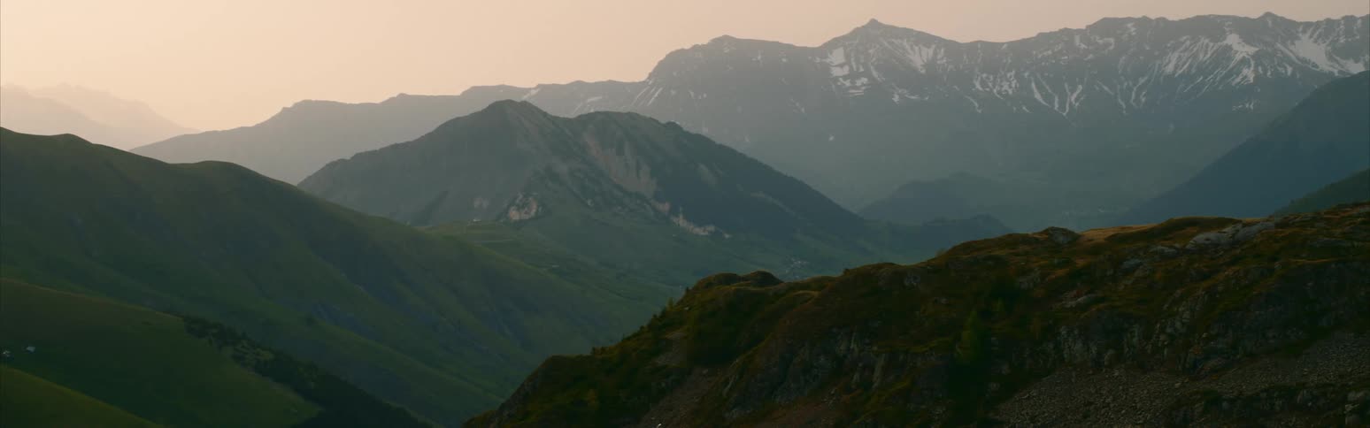 A mountain landscape with snow at sunrise
