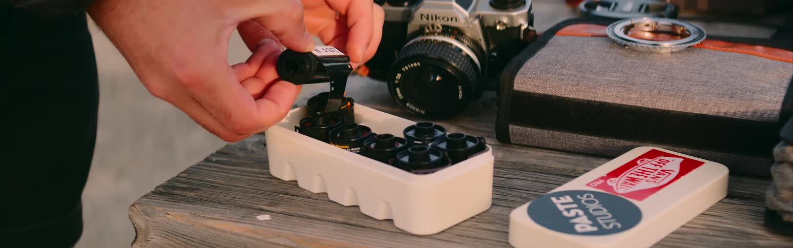 A photographer removes camera film from the box
