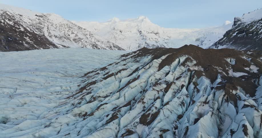 An aerial view of a snow covered mountain landscape in the wilderness