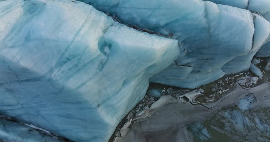 Blue white glacier towers over nearby terrain