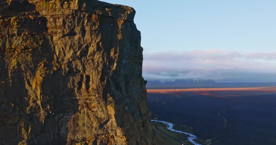 Aerial view of high cliff and open plain near the river
