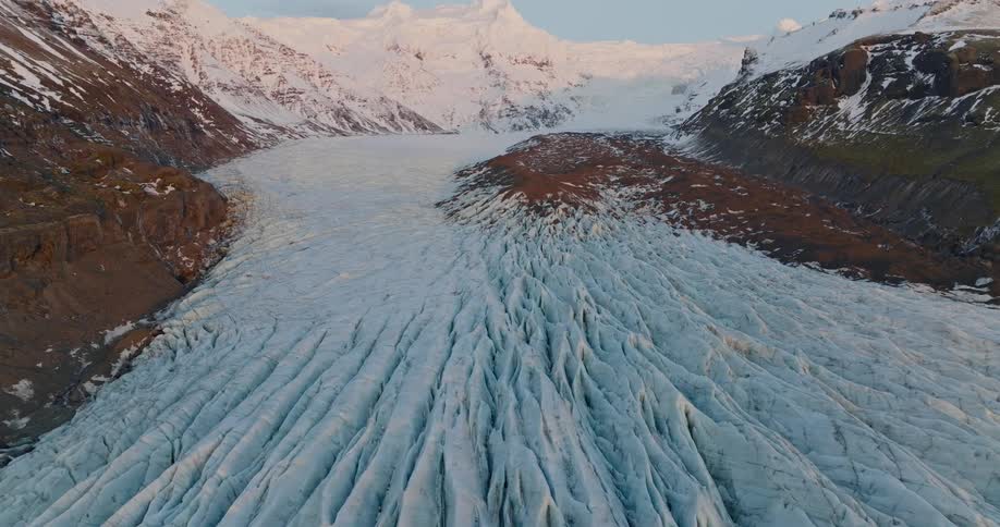A snow covered mountain landscape in the wilderness at dawn