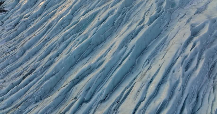 Rugged blue tinted glacier covers slope