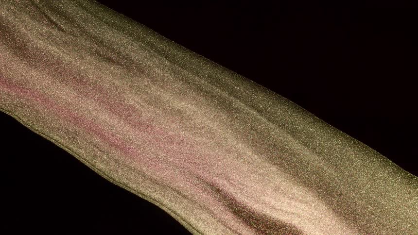 Glittering piece of material rotated to show both sides