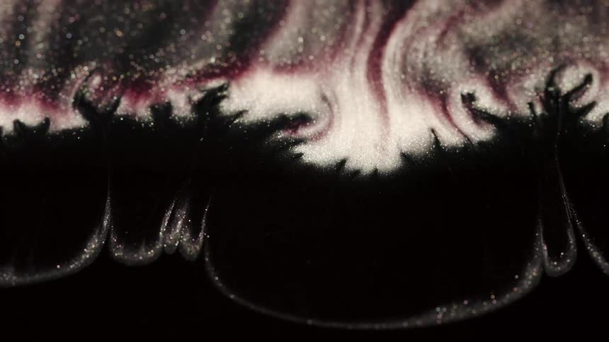 Waves of glitter and color flow in an abstract topography