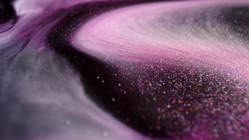 A thick sparkling purple liquid swirling