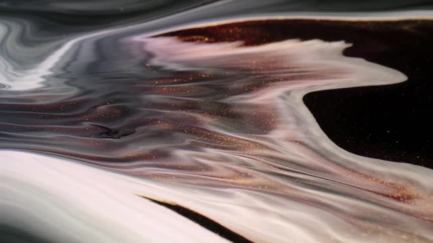 An abstract footage of a colored liquid water mixing