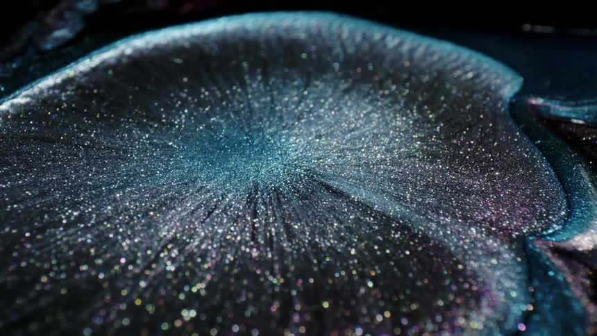 Glitter expands out in a fluid