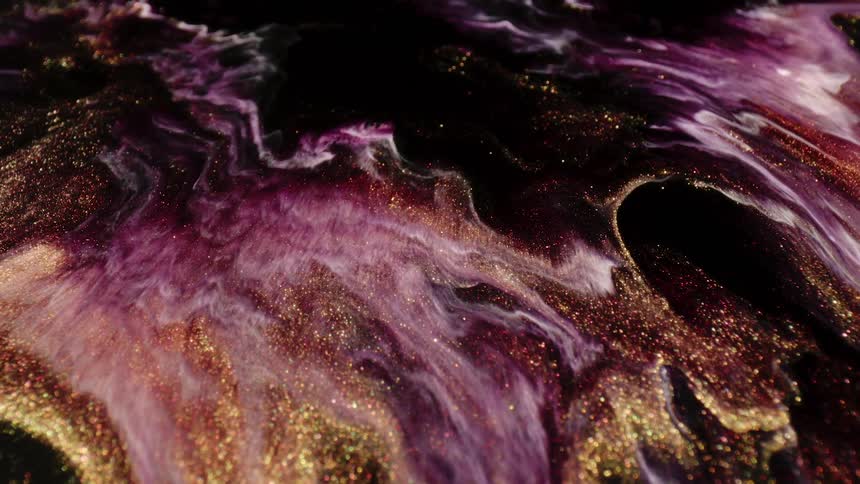 Gold glitter with purple flows and spreads against black in an abstract topography