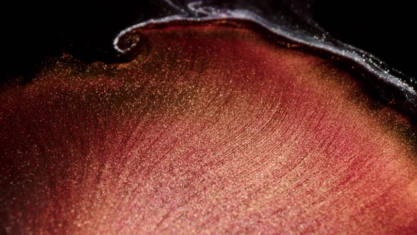 Glittering lines of color sparkle in ruffled petal shaped edge