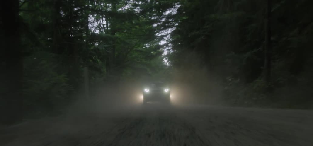 Cars driving down a dirt road