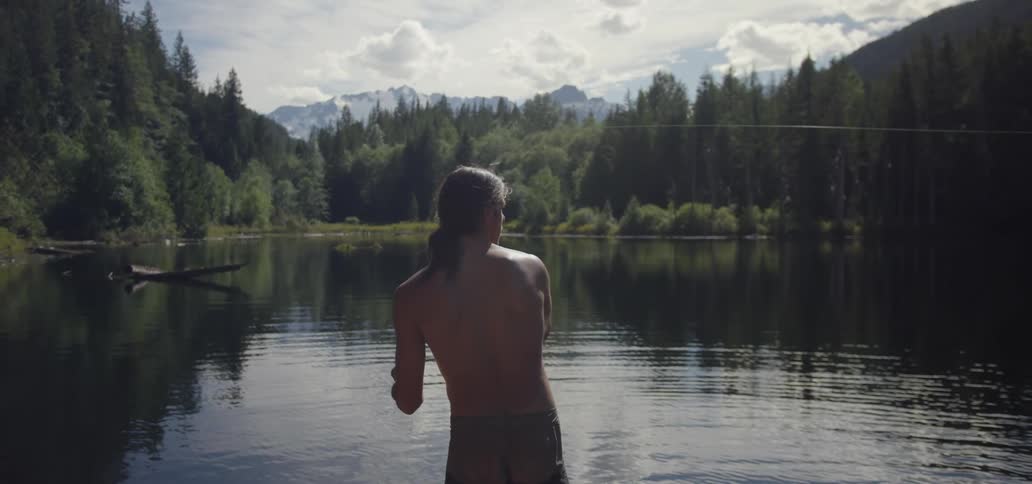 A man is fly fishing in a lake