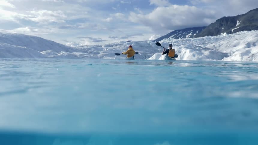 Two kayakers on a supraglacial lake on the icecap