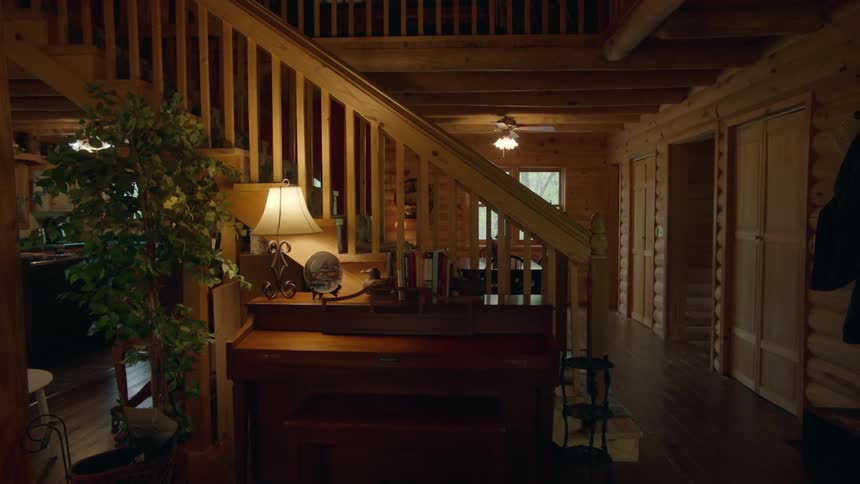 A piano sits alongside a staircase in a home