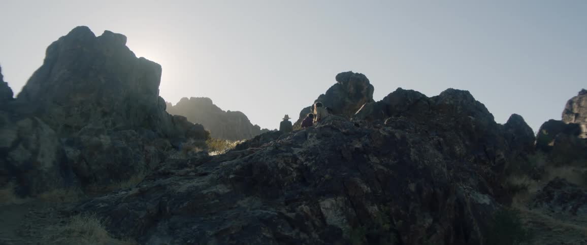 People hiking over rocky terrain in nature
