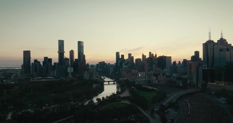 Skyscrapers loom over a metropolis in the evening