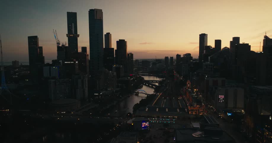 Aerial view of a downtown city at dusk is displayed