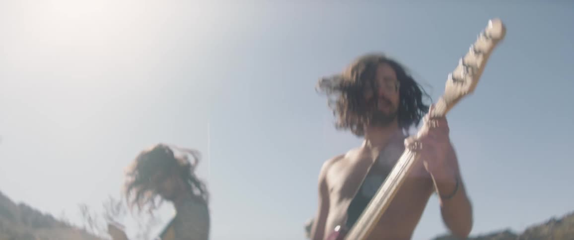 A band is playing outdoors in the nature area