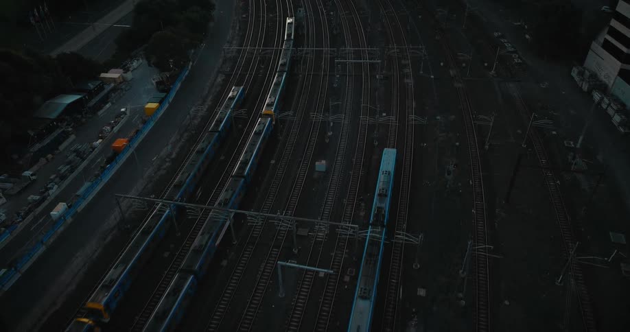 Trains driving past office buildings in a city
