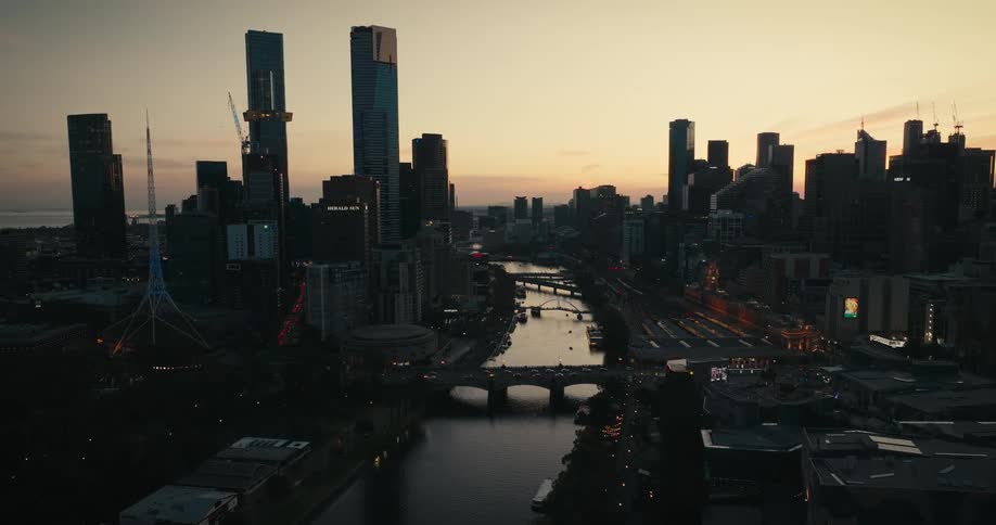 A silhouette of a city landscape against a dusk sky