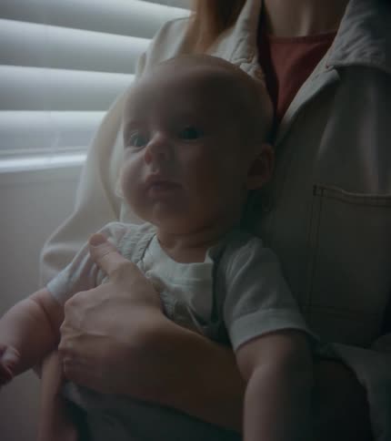 A woman holds her baby in her lap