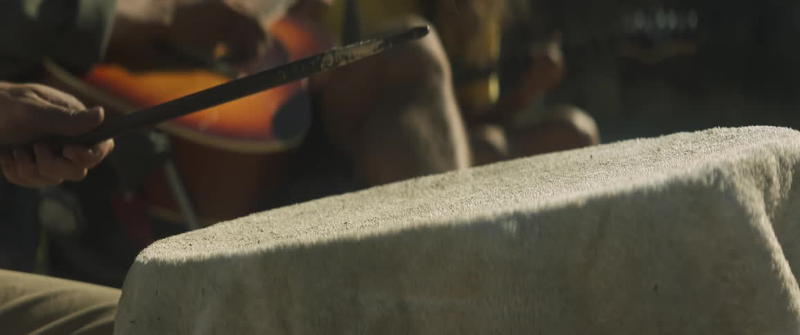 A band with guitarists and a drummer playing a song