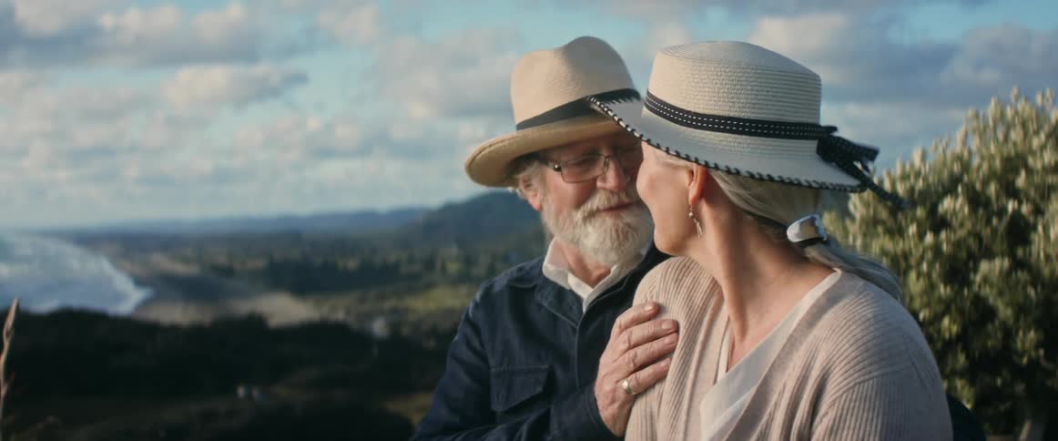A couple kiss on a windy day