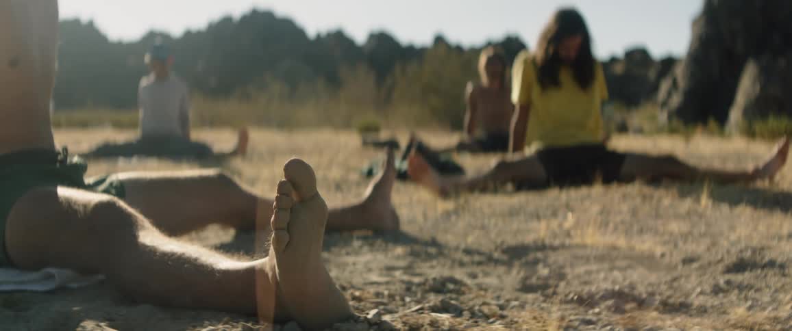 A group of people doing yoga outdoors