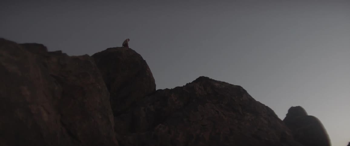 A person is walking on top of the mountains