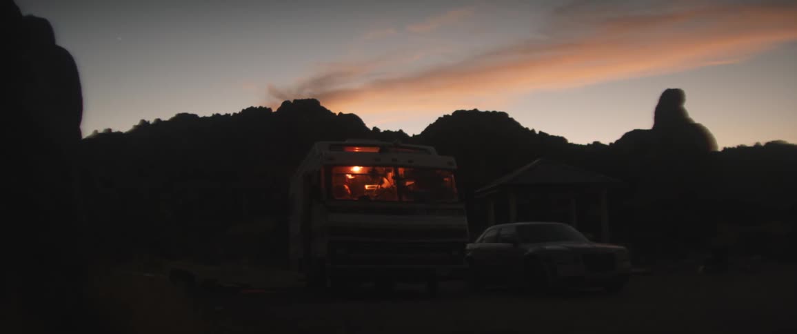 Friends are camping outdoors at night time