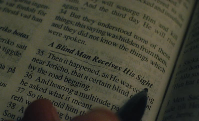 A man underlines text in a book