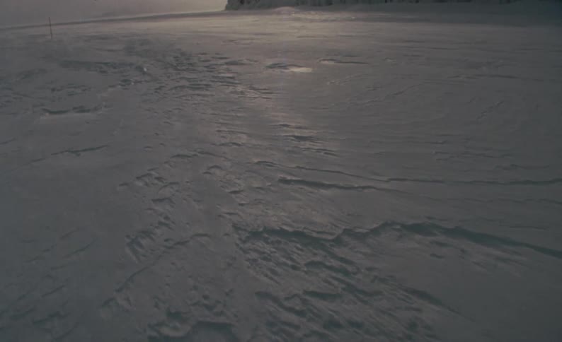 A remote snowy landscape on an overcast day